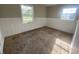This bedroom features carpeted floors, wainscoting and two windows letting in natural light at 9048 E 36Th St, Indianapolis, IN 46235
