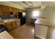 Functional kitchen with wood cabinetry, black appliances, and peninsula seating at 9048 E 36Th St, Indianapolis, IN 46235