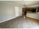 Open kitchen with wood cabinets, black appliances, and dining area with tile floor at 9048 E 36Th St, Indianapolis, IN 46235