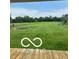 Picture of a large, well-maintained backyard with lush green grass, trees and playground equipment at 911 Centennial Rd, Martinsville, IN 46151