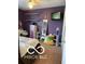 Cozy bedroom features purple walls, shelving, television, bean bag chair and carpeted floors at 911 Centennial Rd, Martinsville, IN 46151