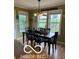 Inviting dining room with a modern light fixture, several windows and rustic decor at 911 Centennial Rd, Martinsville, IN 46151