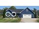 Charming one-story home with blue siding, a two-car garage, and a well-maintained front yard at 911 Centennial Rd, Martinsville, IN 46151