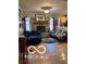 Bright living room features a brick fireplace, hardwood floors and comfortable seating at 911 Centennial Rd, Martinsville, IN 46151