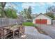 Inviting backyard featuring a patio with a dining set and a detached garage at 914 Kessler Blvd E Dr, Indianapolis, IN 46220