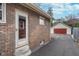 Brick home exterior with view of detached garage and driveway at 914 Kessler Blvd E Dr, Indianapolis, IN 46220