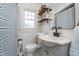 Bright bathroom with updated sink, wood shelves, and classic black and white accents at 914 Kessler Blvd E Dr, Indianapolis, IN 46220