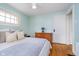 Comfortable bedroom featuring hardwood floors, neutral decor, and a view of the doorway at 914 Kessler Blvd E Dr, Indianapolis, IN 46220