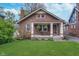 Charming brick bungalow featuring a cozy front porch with a swing and a well-manicured lawn at 914 Kessler Blvd E Dr, Indianapolis, IN 46220