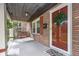 Inviting porch with a swing, wreath, and a 'Hello' welcome mat, creating a warm entry to the home at 914 Kessler Blvd E Dr, Indianapolis, IN 46220