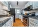 Charming kitchen featuring granite counters, stainless steel appliances, and white cabinets at 914 Kessler Blvd E Dr, Indianapolis, IN 46220