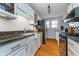 Well-lit kitchen with white cabinets, granite countertops, and stainless steel appliances, offering a modern look at 914 Kessler Blvd E Dr, Indianapolis, IN 46220