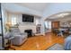 Open-concept living room featuring hardwood floors, a fireplace, and a seamless transition to the dining area at 914 Kessler Blvd E Dr, Indianapolis, IN 46220