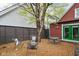 Inviting backyard featuring stylish metal furniture, a large shade tree, and pea gravel ground covering at 946 Stillwell St, Indianapolis, IN 46202