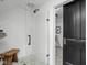 Modern bathroom highlighting a sleek glass-enclosed shower with white tile, complemented by a convenient wooden stool at 946 Stillwell St, Indianapolis, IN 46202