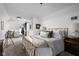 Bright bedroom features plush carpeting, a cozy bed with throw blanket, and comfortable wicker chair at 946 Stillwell St, Indianapolis, IN 46202