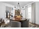 Bright dining room featuring a round table with upholstered chairs under a chandelier at 946 Stillwell St, Indianapolis, IN 46202