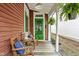 Inviting front porch with outdoor seating, ferns, and a striped rug create a welcoming entrance at 946 Stillwell St, Indianapolis, IN 46202