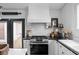Stylish kitchen showcasing stainless steel appliances, white subway tile backsplash, and a view of the backyard at 946 Stillwell St, Indianapolis, IN 46202