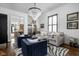 Bright living room featuring elegant chandelier, stylish seating, and view of dining room at 946 Stillwell St, Indianapolis, IN 46202