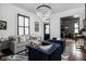 Bright living room featuring stylish seating, elegant chandelier, and shuttered windows at 946 Stillwell St, Indianapolis, IN 46202