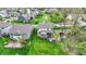 Aerial view of the property showcasing the backyard, creek, and neighborhood setting surrounded by mature trees at 10294 Pigato Dr, Zionsville, IN 46077