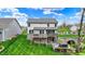Spacious backyard with a well-manicured lawn, multi-tiered deck, and walkout basement to enjoy outdoor living at 10294 Pigato Dr, Zionsville, IN 46077