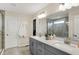 Modern bathroom with double sinks, quartz countertops, grey cabinets, and a glass shower at 10294 Pigato Dr, Zionsville, IN 46077