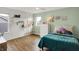 Bright bedroom featuring hardwood floors, turquoise walls, decor and a bed with turquoise bedding at 10294 Pigato Dr, Zionsville, IN 46077