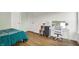 Bedroom featuring hardwood floors, a vanity, two doors and bed with turquoise bedding at 10294 Pigato Dr, Zionsville, IN 46077