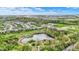 Aerial view of a community featuring a pond, walking trails, playground, and green spaces for outdoor recreation and enjoyment at 10294 Pigato Dr, Zionsville, IN 46077