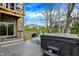 Multi-level deck with a hot tub, lounge chairs, and a view of the lush backyard at 10294 Pigato Dr, Zionsville, IN 46077