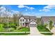 Beautiful two-story home showcases a well-kept lawn and inviting gray facade with a contrasting orange front door at 10294 Pigato Dr, Zionsville, IN 46077