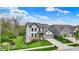 Stunning exterior view of a well-maintained home with lush landscaping and a charming stream running alongside the property at 10294 Pigato Dr, Zionsville, IN 46077