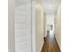 Bright hallway featuring hardwood floors and neutral paint, leading towards the kitchen at 10294 Pigato Dr, Zionsville, IN 46077