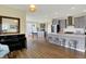 Open concept kitchen with grey cabinets, an island with seating, and an adjacent living area at 10294 Pigato Dr, Zionsville, IN 46077