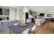 Open-concept kitchen boasts stainless steel appliances, an island with seating, and an adjacent dining area at 10294 Pigato Dr, Zionsville, IN 46077