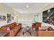 Bright living room with a ceiling fan, and complete with a comfortable orange couch and a decorative glass coffee table at 10294 Pigato Dr, Zionsville, IN 46077