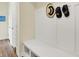 Mudroom features a built-in bench with storage, white walls and ample room for coats and shoes at 10294 Pigato Dr, Zionsville, IN 46077