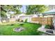 A backyard area features a fire pit, detached garage and partial fence at 1030 N Butler Ave, Indianapolis, IN 46219