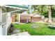 Spacious backyard featuring a fire pit, detached garage and partial fence at 1030 N Butler Ave, Indianapolis, IN 46219