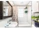 Bright bathroom with subway tile, plants, and a shower and tub combination at 1030 N Butler Ave, Indianapolis, IN 46219