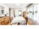Bright dining room with hardwood floors, greenery and bright light from large window at 1030 N Butler Ave, Indianapolis, IN 46219