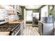 Well-lit kitchen with stainless steel appliances, butcher block countertops, and mosaic backsplash at 1030 N Butler Ave, Indianapolis, IN 46219