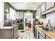 Efficient kitchen featuring stainless appliances, updated cabinets, and tile backsplash at 1030 N Butler Ave, Indianapolis, IN 46219