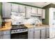Bright kitchen features updated cabinets, butcher block countertops, and a modern backsplash at 1030 N Butler Ave, Indianapolis, IN 46219