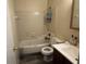 Standard bathroom with a shower-tub combo, white tile, and a single-sink vanity at 10569 Folsom Dr, Indianapolis, IN 46235