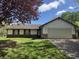 Charming single-story home with a well-maintained lawn and an attached two-car garage at 10569 Folsom Dr, Indianapolis, IN 46235