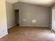 A blank canvas living room with wood floors, a sliding glass door, and freshly painted grey walls at 10569 Folsom Dr, Indianapolis, IN 46235