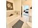 Bright bathroom with a tub and shower, and a view into a bedroom at 1119 E Main Cross St, Edinburgh, IN 46124